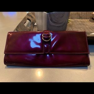 Bandolino wine colored patent leather clutch